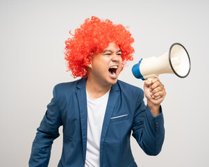 Shout out loud with megaphone. Young Asian man with afro Hairstyle. Funny smiling happiness man...