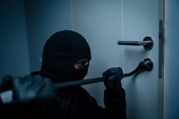 Thief in uniform black jacket various action housebreak. The Robber terrorism criminal escapes with...