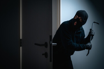 Thief in uniform black jacket various action housebreak. The Robber terrorism criminal escapes with...