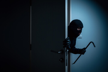 Thief in uniform black jacket various action housebreak. The Robber terrorism criminal escapes with...