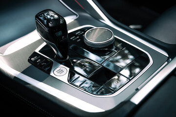 Close up of the manual gearbox transmission handle. Accelerator handle and buttons in a new car.