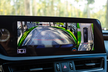 Close-up of monitor with view from reversing camera with parking in park area