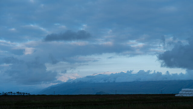 clouds over landscape in iceland