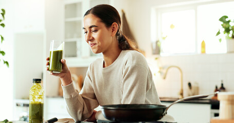 Woman, smoothie and drink in kitchen for health, nutrition and breakfast with morning cooking....