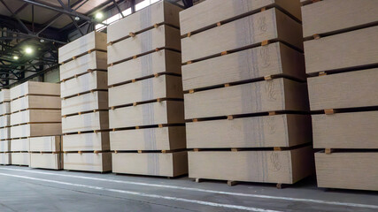 A warehouse full of wooden boards stacked on top of each other