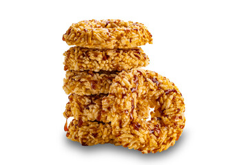 Side view tower stack of crispy homemade rice crackers with cane sugar syrup isolated on white background with clipping path, closeup.