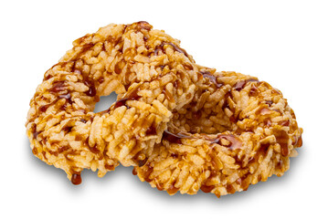 Closeup view of crispy homemade sweet rice crackers with cane sugar syrup isolated on white background with clipping path.