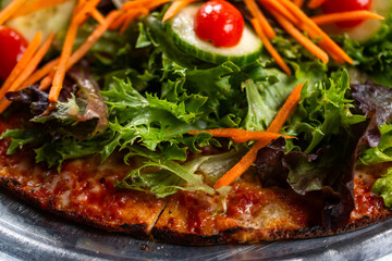 Salad pizza on a metal tray 