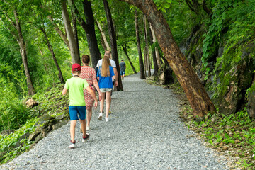 Tourists walk through Thailand's Death Railway, built using forced labor during World War II,...