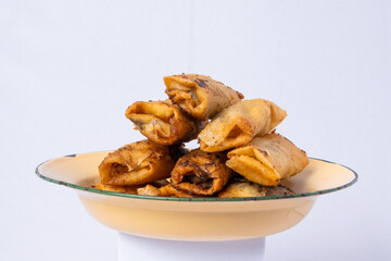 deep-fried chocolate banana on a yellow rustic plate and white isolated background