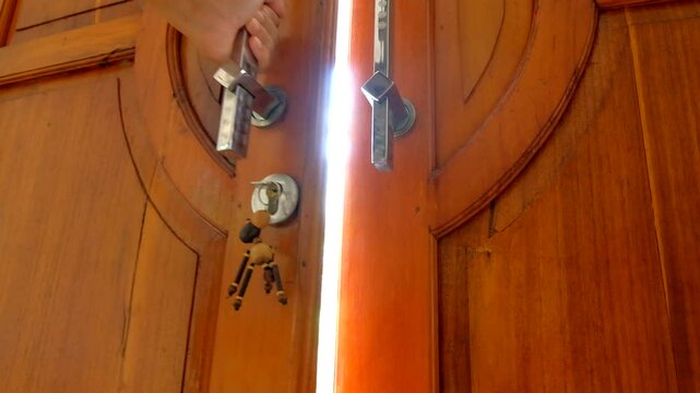 a man's hand is opening a door or doorknob to go outside