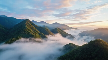 misty mountain range at sunrise, enveloped in soft clouds and bathed in gentle light, creates serene and tranquil atmosphere