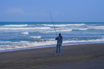 man fishing from the shore