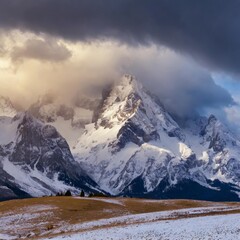 Dramatic snow-capped peaks with storm clouds gathering above, creating a powerful winter scene
