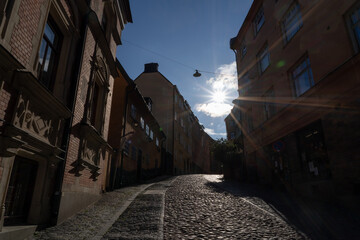 Stockholm, Sweden - 23rd of July 2023. A steep cobblestone street in the early morning sun in Stockholm, Sweden.