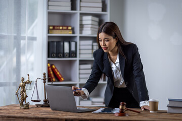 Lawyer business woman working with law books in the office or courtroom Legal counsel with gavel and legal law. justice and lawyer concept Judge gavel hammer on Lawyer desk
