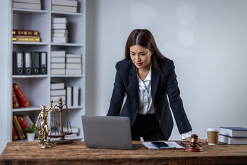 Fototapeta premium Lawyer business woman working with law books in the office or courtroom Legal counsel with gavel and legal law. justice and lawyer concept Judge gavel hammer on Lawyer desk 