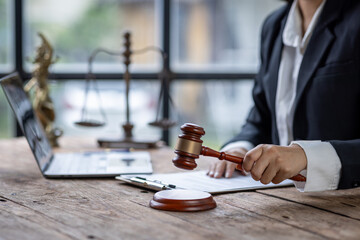 Close up of lawyer or business woman judge working with lawbook in the office or courtroom. gavel and legal law justice and lawyer concept 
