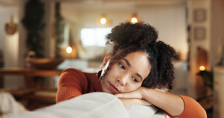 Heartbreak, sad and thinking with face of woman on sofa in living room of home for contemplation....