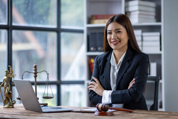 Obraz premium Lawyer woman or business woman working with contract documents on laptop law office or courtroom, gavel Law and justice concept. 