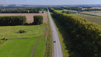 The car is driving along the road