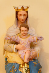 Statue of Blessed Virgin Mary holding baby Jesus Christ in her arms.