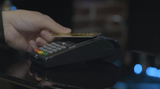 Close-up shot of person using mobile payment PayPass.