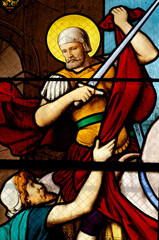Obraz premium Stained glass of Saint Martin of Tours cuting a piece of his cloak for a beggar. Saint of the Roman Catholic Church.