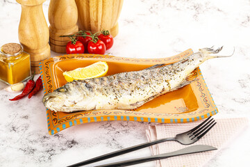 Grilled sea bass fish served lemon