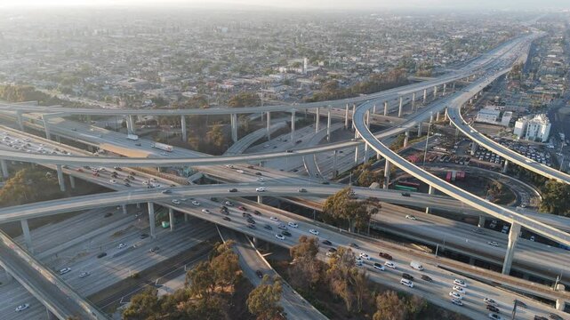 wide arial shot of urban highway intersection traffic. Los Angeles, California. Drone 4k