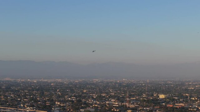 Arial view on Hellicopter flying across the Los Angeles Suburbian area towards the Down Town, Sunset, California, 4k Drone