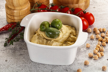 Tasty hummus with green olives