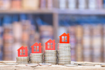 Mortgage loan or home equity loan, financial concept : Tiny model residential house perched atop...