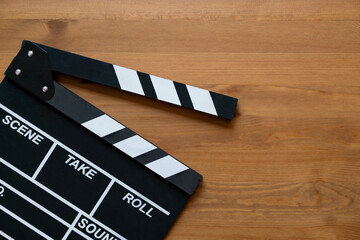 movie clapper on wood table ; film, cinema and video photography concept