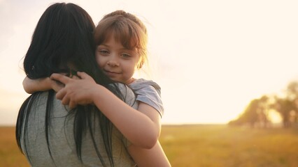 daughter hugging mom. happy family a kid dream concept. mother carries her daughter in her arms...