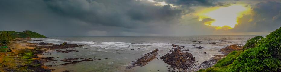 Beautiful Sunset at the Beach with Rock and Mountain, Goa, India. Vagator Beach View. Famous Sunset view point.