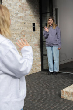 Women waving bye to each other