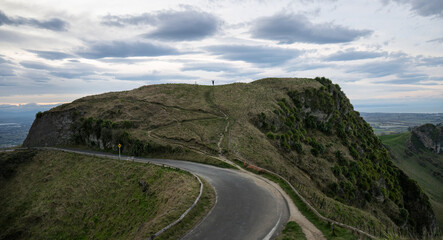 Woman raising arms and standing on top of the hill. Te Mata Peak. Hawke&rsquo;s Bay.