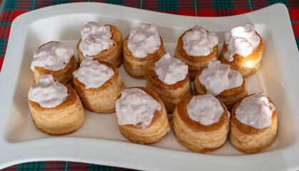 Homemade appetizer of voulevants filled with ham cream