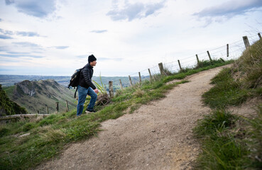 Man hiking steep uphill on Te Mata Peak track. Hawke’s Bay.