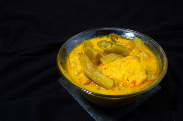 sayur lodeh in a bowl on a black background. Sayur lodeh is a typical Indonesian vegetable dish...