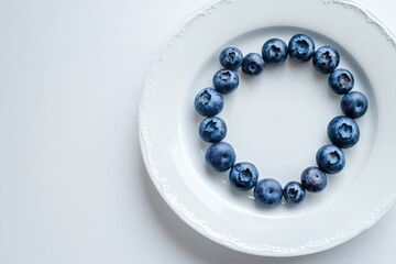 Blueberries Arranged in a Circle on a White Plate