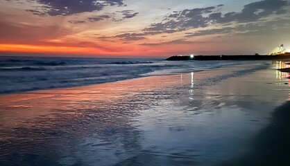 A serene sunset in Carlsbad, California, with vibrant hues reflecting on the ocean�s surface and...