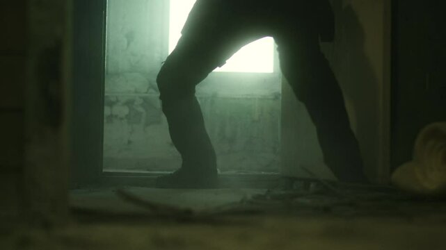 SWAT Operative Kicking Down Door in Smoky Room During Raid