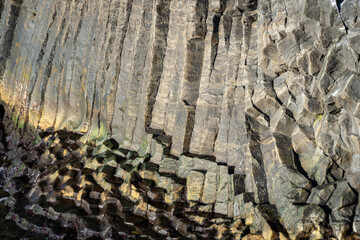 Natural structures and shapes from Iceland. Beautiful natural scenery for the background. Rock wall texture. Granite, basalt, gneiss and other intrusive or effusive rocks.