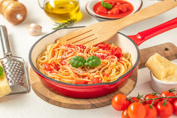Spaghetti pasta in pan. Italian pasta with tomato sauce and basil