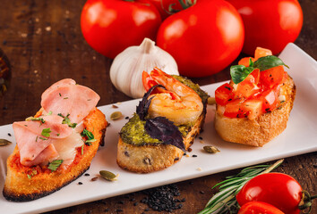 Delicious italian appetizer bruschetta presenting variety of toppings