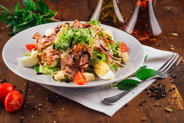 Fresh and healthy caesar salad with dressing on white plate