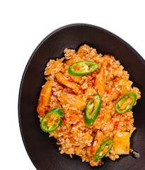 Sweet and sour chicken with rice and pineapple in black bowl