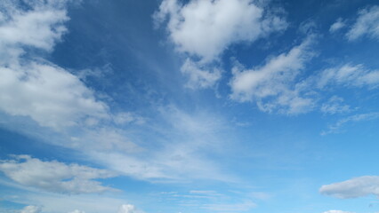 Floating fluffy clouds. Beautiful sunny blue sky with wispy smoky white cumulus and cirrus on different layers. Timelapse.